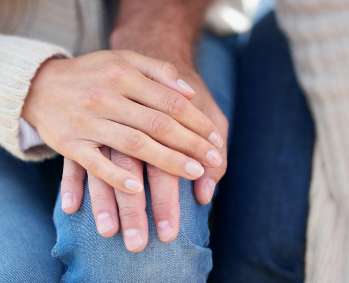 Woman is holding men's hand